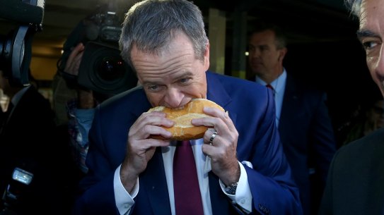 The controversial moment as Bill Shorten bites into a sausage sizzle...from the side.