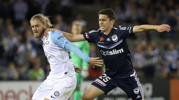 Pasquali, right, battles with Victory's Luke Brattan during the Melbourne derby.