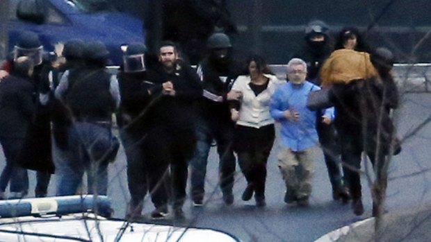 Members of the French police special forces evacuate the hostages after launching the assault at a kosher grocery store.