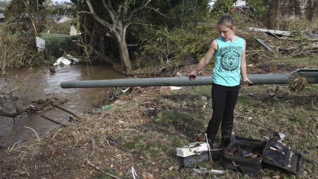 Tatum Taylor searches for her family's possessions where their house used to be in Dungog in the upper Hunter region of NSW.