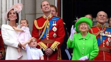 Queen Elizabeth II (in green) is surrounded by family during her 90th birthday celebrations.  