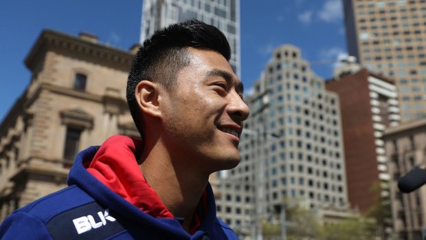 Still smiling: Lin Jong of the Bulldogs during the grand final parade.
