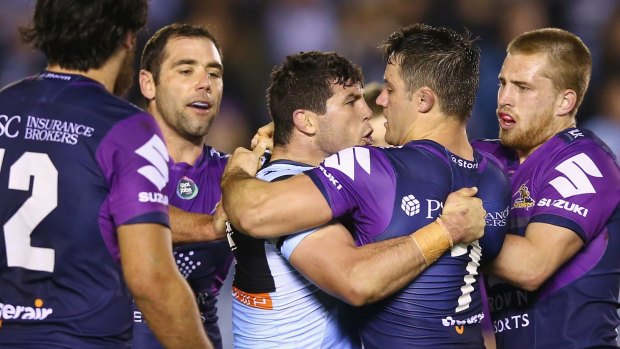 Heated rivalry: Michael Ennis and Cooper Cronk scuffle.