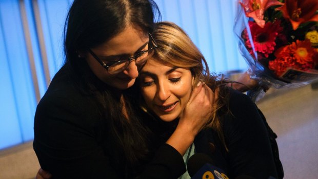 Sahar Muranovic, left, and her sister Sara Yarjani, an Iranian student who was detained for 23 hours and deported back to Vienna, were reunited at Los Angeles International Airport on Sunday.