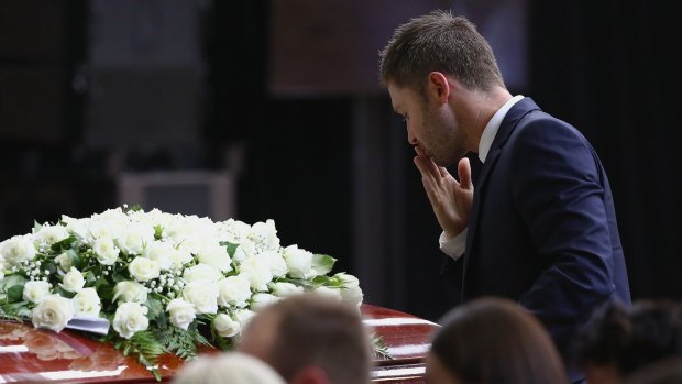 Australian cricket captain Michael Clarke pays his respects to fellow Test cricketer Phillip Hughes, who died after a freak bouncer hit him in the neck. 