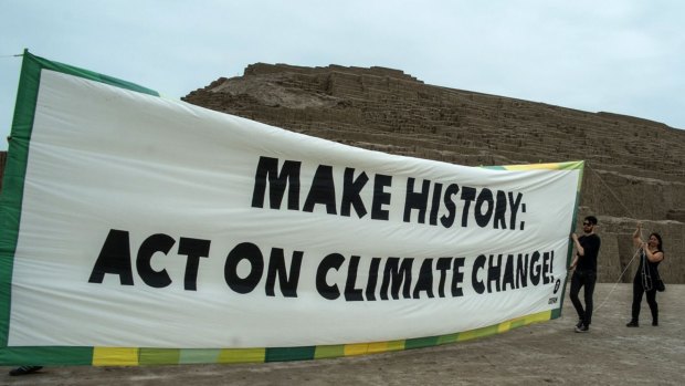Protest: Oxfam members hold a banner at the archaeological site of Huaca Pucllana in Lima.