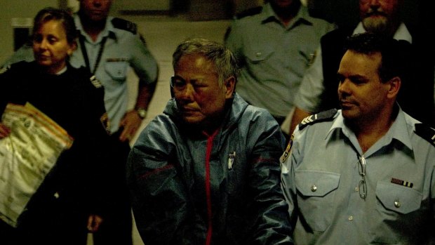 Philip Nguyen is led away by police after the shoot-out in September 2010 in which Constable Bill Crews was killed. 