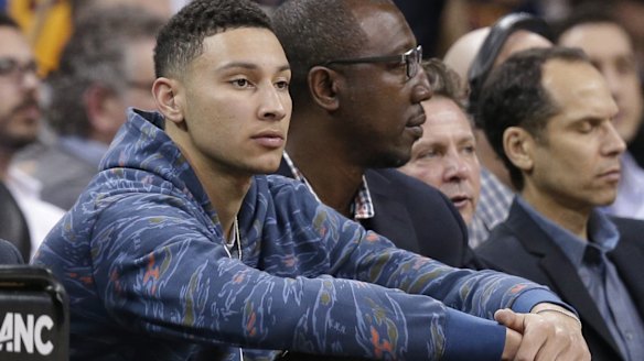 LSU's Ben Simmons sits court side in the first half of an NBA game between the Milwaukee Bucks and the Cleveland Cavaliers.