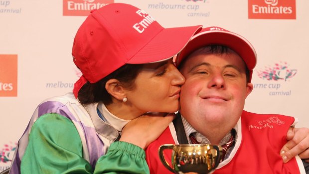 Michelle Payne celebrates her winning ride with brother and strapper Stephen Payne.