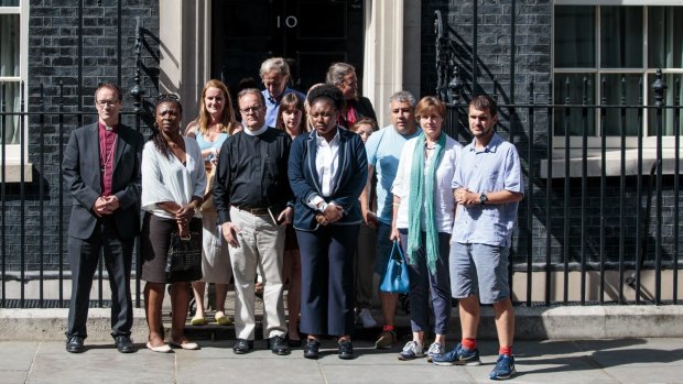 Victims, relatives volunteers and community leaders of the Grenfell Tower fire disaster leave Number 10 Downing Street.