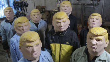 Factory workers at the Shenzhen Yongtaida Latex Crafts ham it up in Donald Trump masks.
