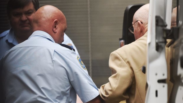 Roger Rogerson being led into the Supreme Court in Sydney on Monday.