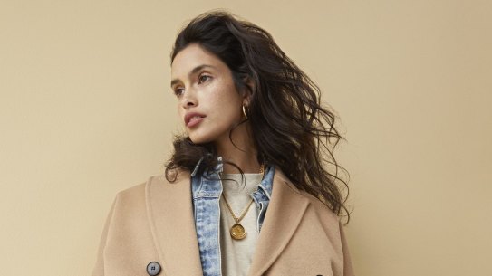 Zara coat, $259. Camilla and Marc “Gisella” jacket, $330, “Prosper” jumper, $199, and “Prosper” track pants, $199. Reliquia “Coralia” earrings, $139, and “Nugget of Wisdom” necklace, $179. Louis Vuitton “Twist” bag, $5050. 