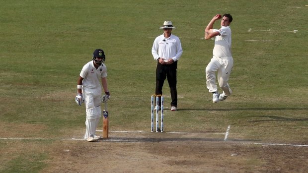 Australia's Pat Cummins, top right, bowls to India's Murali Vijay, foreground.