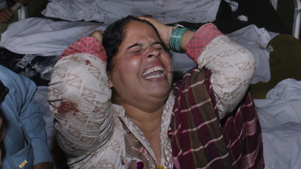 A woman mourns for her relative after a suicide attack on the Pakistani-Indian border on Sunday. 