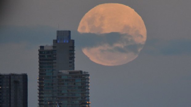 The super blue moon rises above station pier, from Williamstown. 