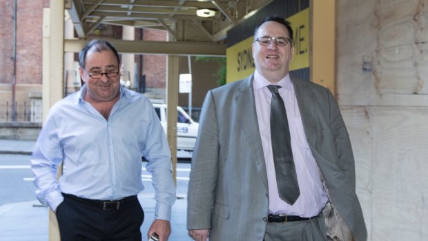 Andrew Sigalla (right) leaves the Supreme Court during his trial.