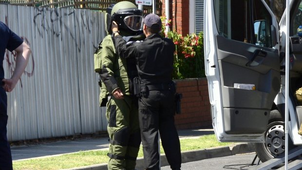 A member of the bomb squad investigates after possible explosives were handed in to St Kilda Police Station.