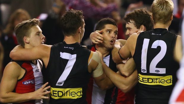 Leigh Montagna of the Saints is mobbed by his teammates after kicking the winning goal against Melbourne.