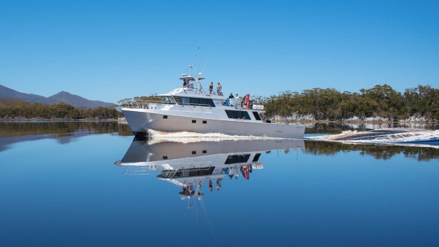 The Odalisque cruising the mirrored waters of Bathurst Harbour.