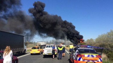 A truck has rolled and caught fire on the Federal Highway.