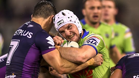 Jarrod Croker of the Raiders is tackled. 