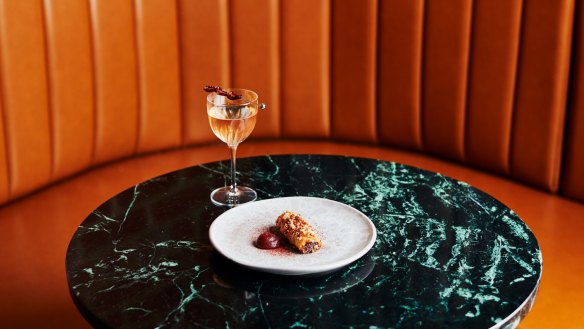 A cocktail and duck baklava with tamarillo chutney at Navi Lounge.