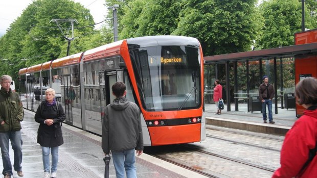 Happy commuters of Bergen admire their  light rail trams.