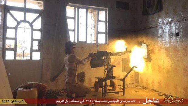 An Islamic State militant fires an automatic weapon against Kurdish Peshmerga fighters in the village of Tel el-Reem, in Iraq, in this photo posted on a militant website last month. 