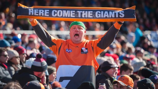 A Giants fan shows his passion at Manuka Oval.