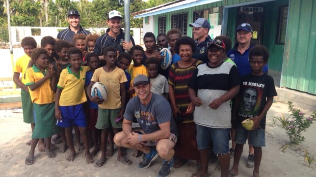 Helping the locals: Brian Norrie, Daniel Holdsworth, Adam Peek, Corey Hughes and Steve Pike (top right) in the New Ireland province of Papua New Guinea.