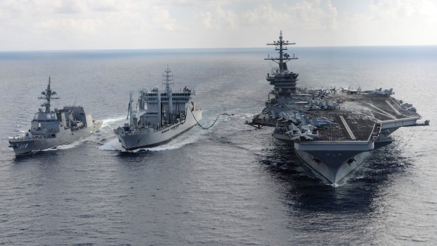In this 2015 US Navy picture, the aircraft carrier USS Theodore Roosevelt and Japanese Maritime Self-defence Force Akizuki-class destroyer JS Fuyuzuki transit alongside the Indian Deepak-class fleet tanker INS Shakti during Exercise Malabar.