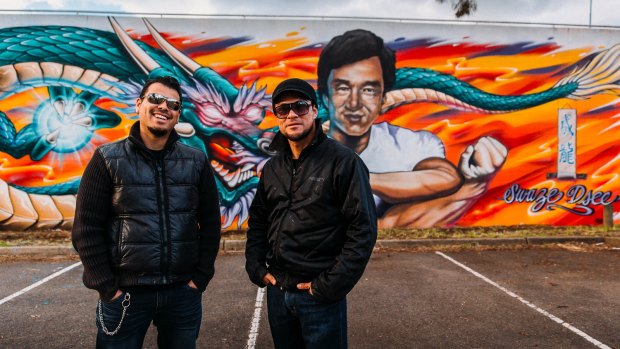 Artists David Chavez aka DSEE and Ian Ballesteros aka Swaze with their completed mural of Jackie Chan in Dickson.