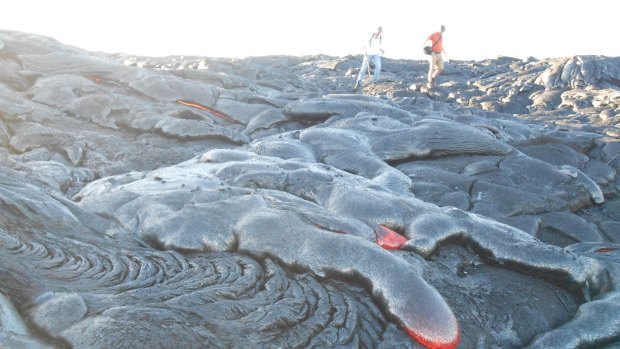 People walking among flowing lava.