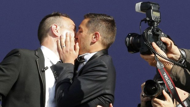 Vincent Autin, left, and Bruno Boileau kiss after they were the first gay couple to marry in France.