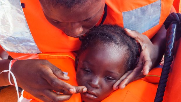 Sara Traore, a two-year-old girl from Ivory Coast, is rescued from a rubber boat sailing out of control about 24 kilometres north of Al Khums, Libya.