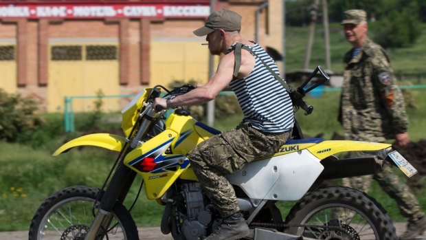 Arsen Pavlov, also known as Motorola, rides a bike at a checkpoint in eastern Ukraine. 