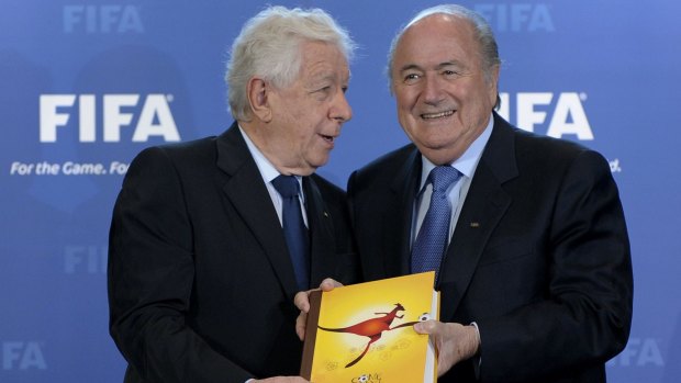 Frank Lowy presents Sepp Blatter with the official bid document in 2010. 