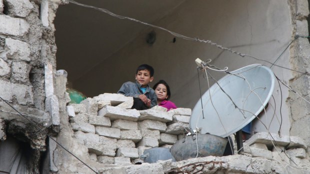Children in a partially destroyed home in Aleppo, Syria, this week.