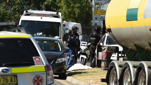 Emergency services near a body outside the scene of a stand-off between police and a gunman on Stennett road at Ingleburn. 