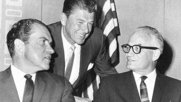 Ronald Reagan leans in to talk with Richard Nixon and Barry Goldwater (with glasses), the 1964 Republican presidential candidate.