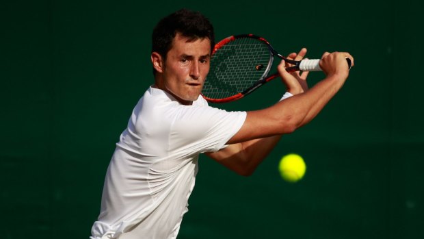 Bernard Tomic in action against Roberto Bautista Agut of Spain.