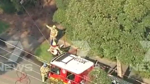 Firefighters at the scene of the fatal house fire in Balwyn on Friday.