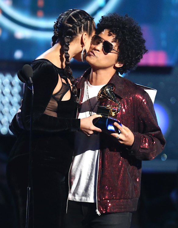 Alicia Keys presents Bruno Mars with the award for record of the year.