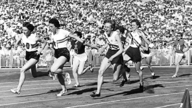 Betty Cuthbert takes the baton from Fleur Mellor on the final leg in the 4x100 metres relay at the Melbourne Olympics.
