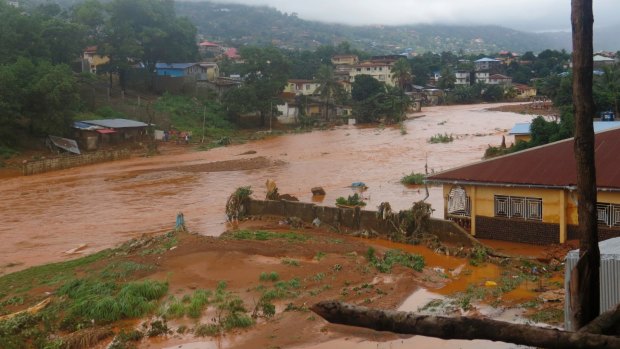 A torrent of water flows through a flooded neighbourhood in Regent, east of Freetown, Sierra Leone, in August.