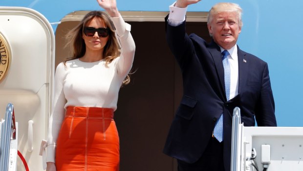 Donald Trump and first lady Melania Trump, wave as they board Air Force One for his first overseas trip as President.