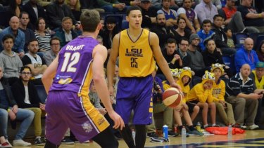 Rising star back home: Australian forward Ben Simmons takes the ball up for LSU against Sydney Kings centre Angus Brandt.