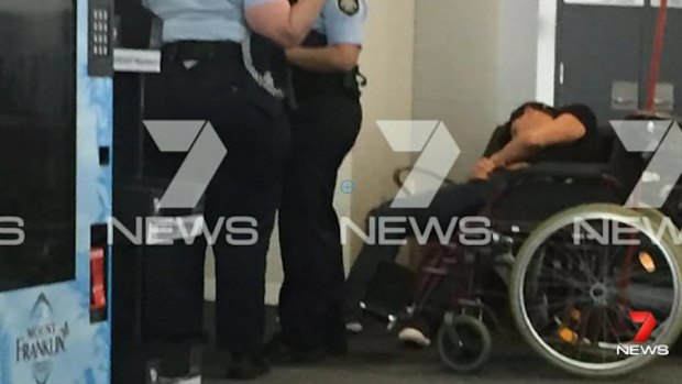 This image, sent to Seven News, purports to show Grant Hackett slumped over next to police at Melbourne Airport.