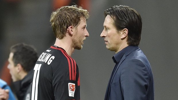 Leverkusen's Stefan Kiessling talks to coach Roger Schmidt.